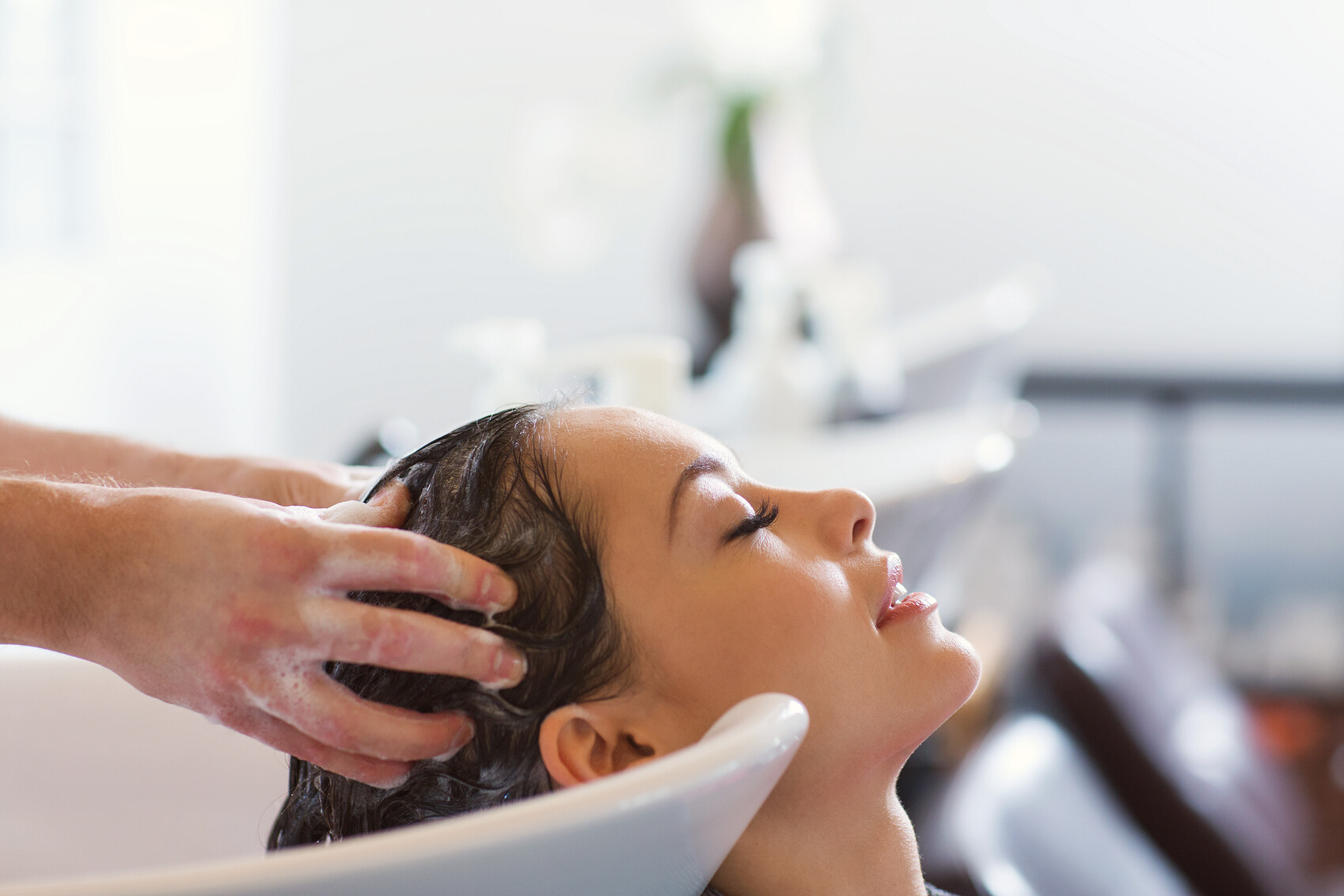 Happy Young Woman at Hair Salon